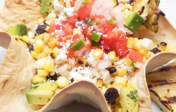 A delicious and flavorful elote bowl with a twist of grilled pineapple for a sweet and savory combination.