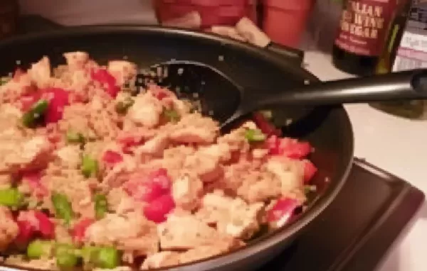 Healthy and flavorful quinoa dish with tender chicken, fresh asparagus, and savory red peppers.