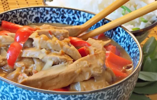 Slow Cooker Thai Pork with Peppers - Tender and flavorful pork cooked in a rich and spicy Thai sauce, topped with colorful bell peppers.