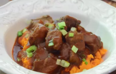 A hearty and flavorful beef stew with a kick of red chili, served over creamy mashed sweet potatoes