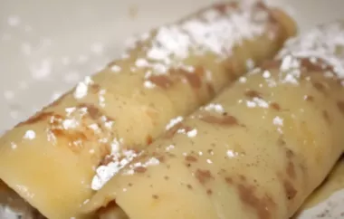 Indulge in a delicious breakfast treat with these Chocolate Crepes topped with sliced bananas.