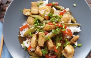 Spicy and savory Szechuan chicken served with vibrant bell peppers and tender peas on a bed of fluffy rice