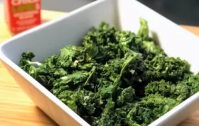 Crispy and flavorful kale chips cooked in an air fryer with a sprinkle of parmesan cheese.