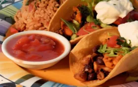 Delicious and nutritious vegetarian tacos filled with black beans, corn, and avocado salsa.